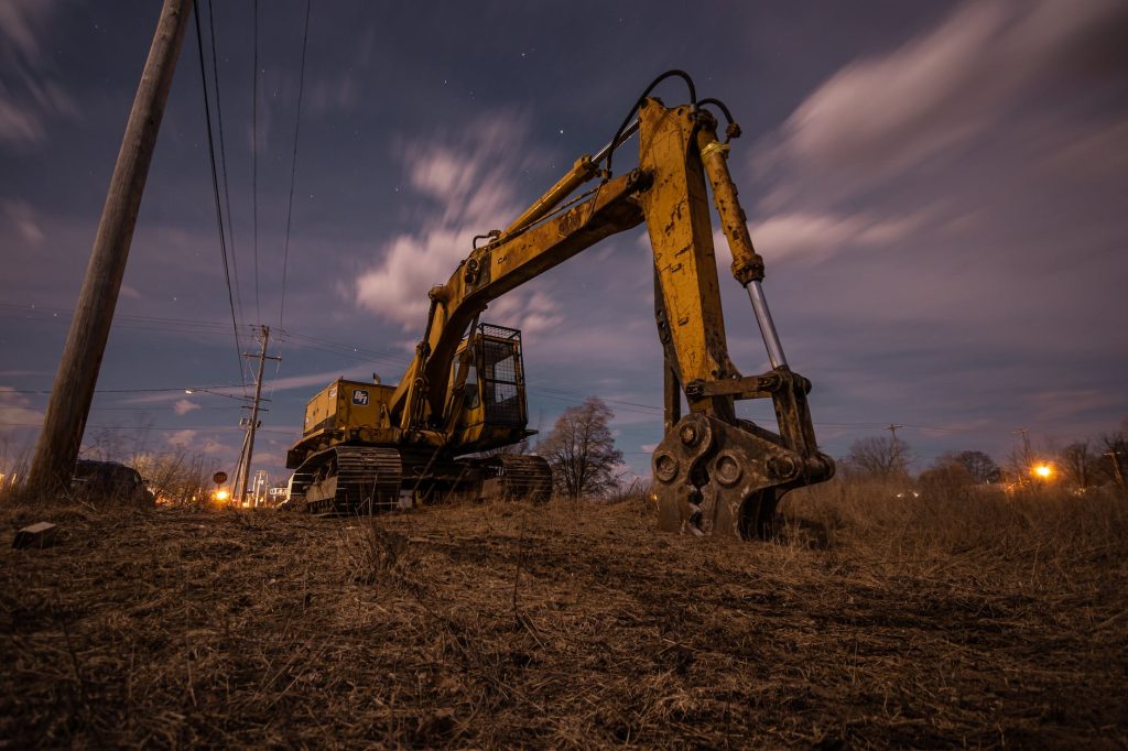 excavator on field at down